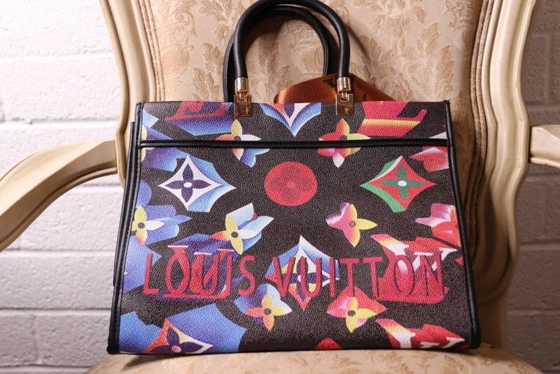 A louis vuitton bag sitting on top of a table.