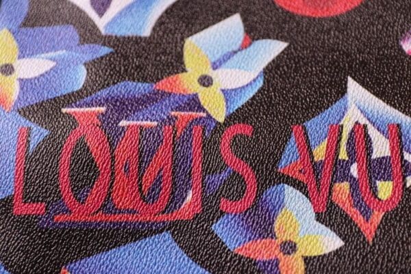 A close up of the words louis vuitton on a bag