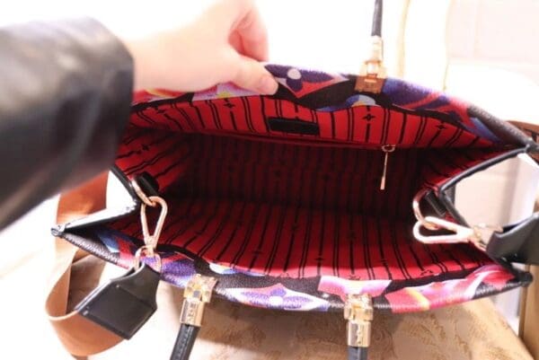 A person holding onto the inside of their purse