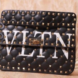 A black and white bag with gold studs on it