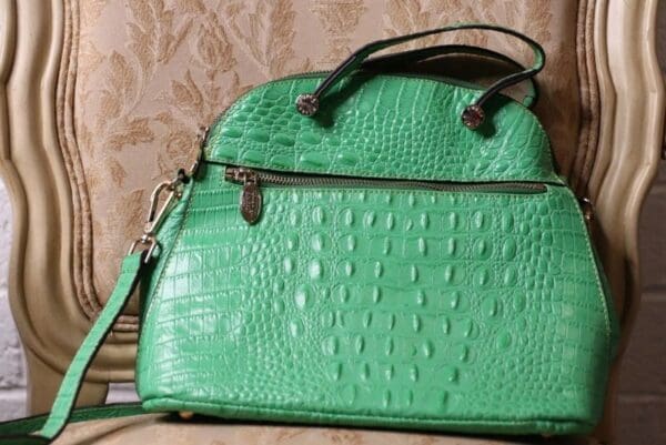 A green purse sitting on top of a wall.