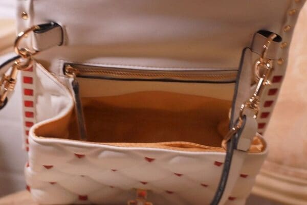 A purse that is open and has a handle.