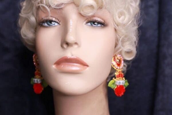 A mannequin with blonde hair and red earrings.
