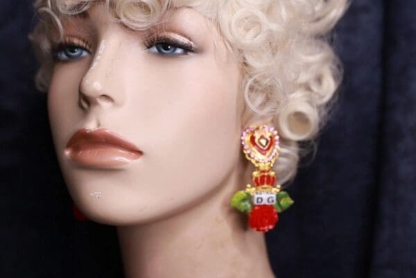 A mannequin wearing earrings with red and green accents.