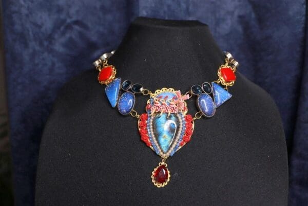 A necklace with blue and red stones on it