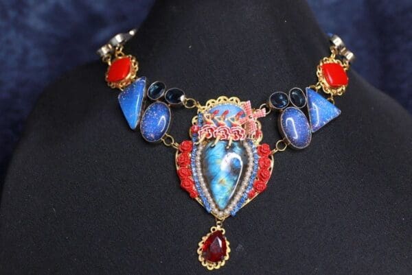 A necklace with blue and red stones on it.