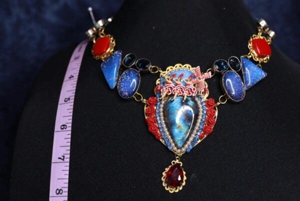 A woman wearing a necklace with a picture of a heart on it.