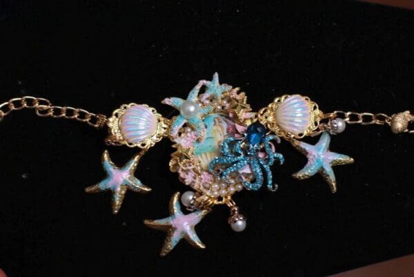 A necklace with sea shells and starfish on it.