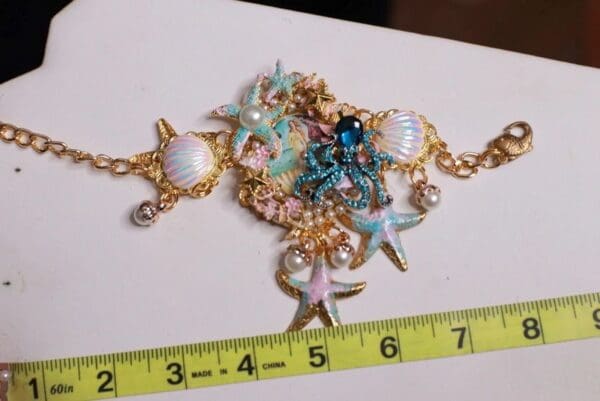 A necklace with sea shells and starfish on it.