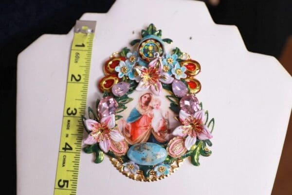 A picture of a piece of art with flowers and a ruler.