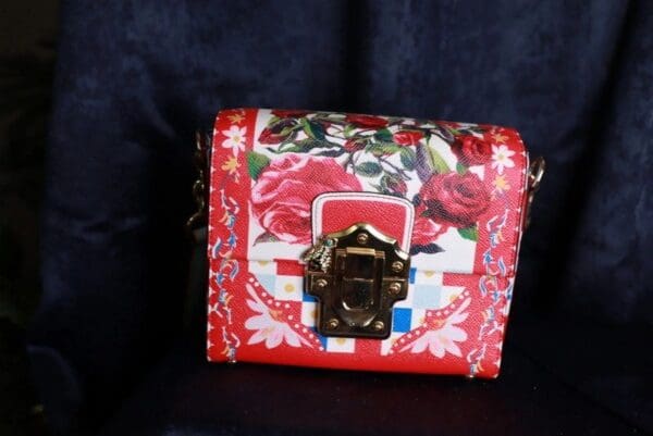 A red purse with roses on it
