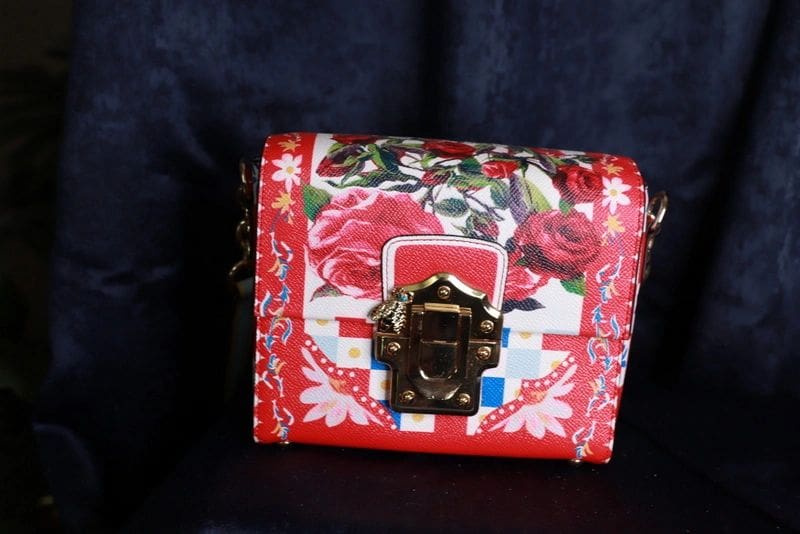 A red purse with roses on it