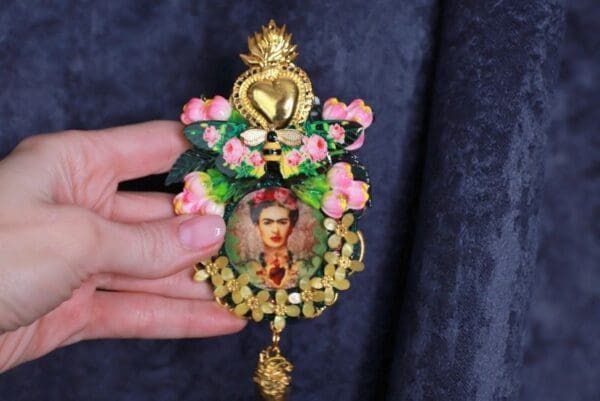 A person holding onto a decorative ornament