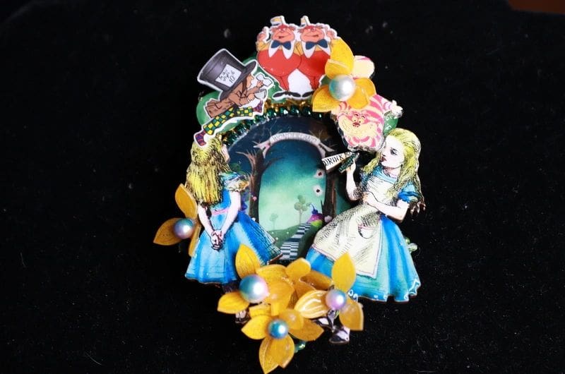A picture of the alice in wonderland pin.
