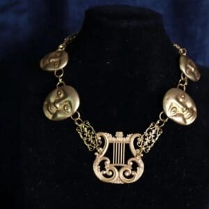 A necklace with a harp and some coins on it