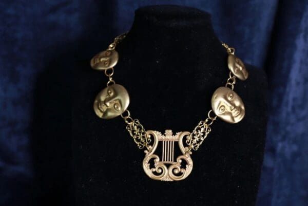 A necklace with a harp and some coins on it