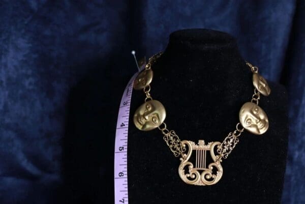 A necklace with a measuring tape and a black background