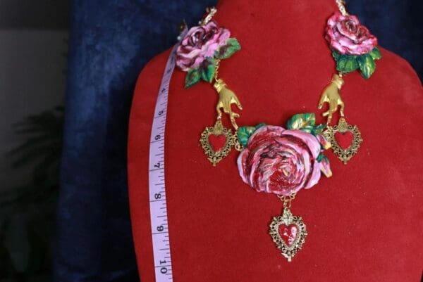 A red dress with a necklace and earrings on it