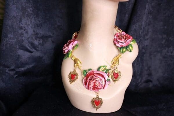 A necklace with roses and hearts on it.