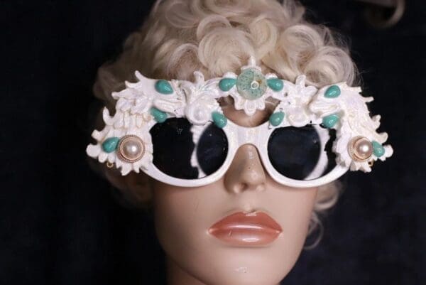 A mannequin wearing sunglasses with flowers on them.