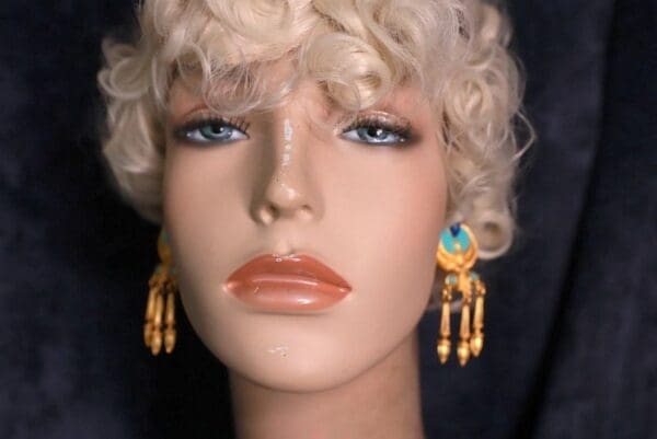 A mannequin with blonde hair and blue eyes.