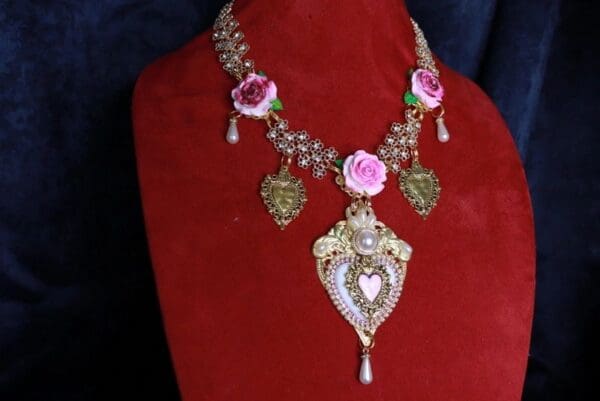 A red velvet display with a necklace and earrings.