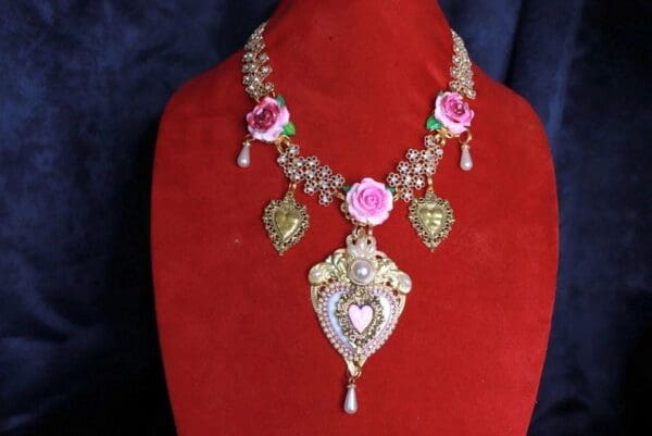 A red velvet display with a necklace and earrings.