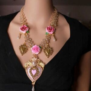 A woman wearing a necklace with pink roses.