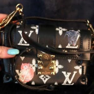 A woman holding onto a louis vuitton bag