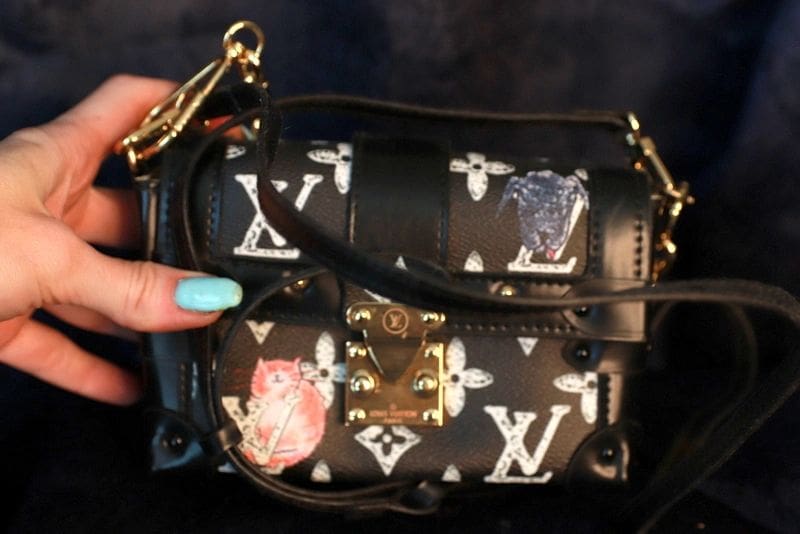 A woman holding onto a louis vuitton bag