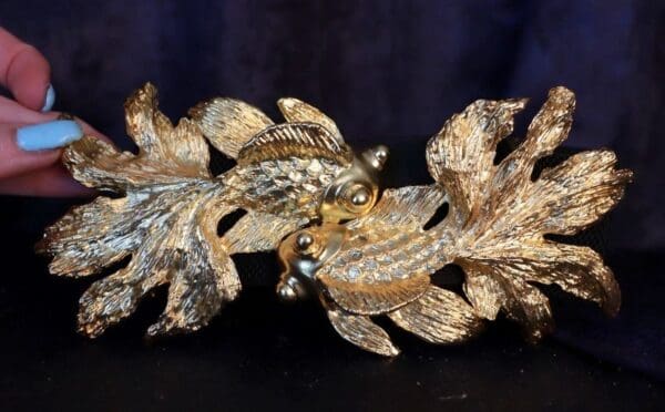 A close up of the back end of a gold leaf sculpture
