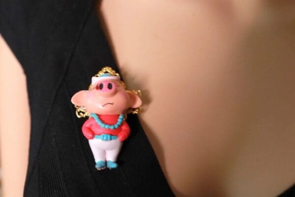 A close up of a pin with a cartoon character