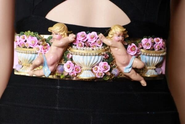 A close up of a wall with some little cherubs