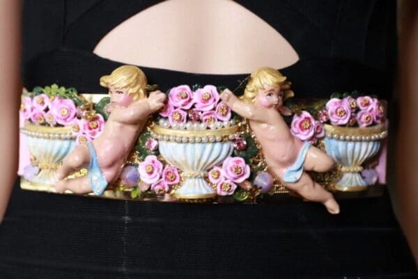 A close up of a plaque with cherubs and flowers
