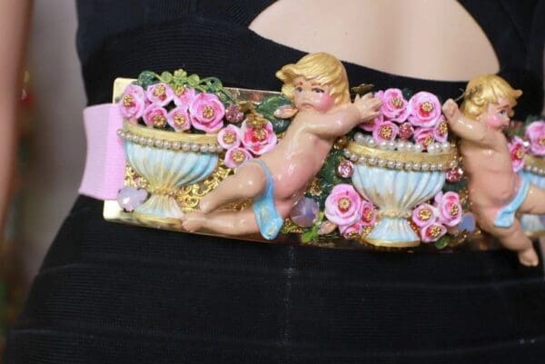 A close up of a belt with a picture of a cherub