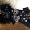 A close up of some black jewelry on top of a table.