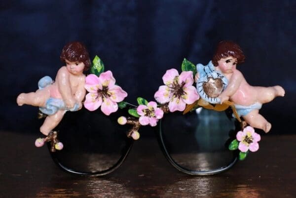 A pair of glasses with figurines on them.