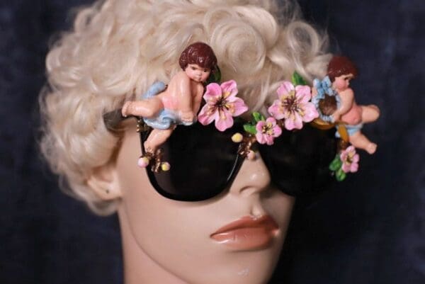 A mannequin wearing sunglasses with flowers and angels on it.