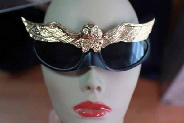 A woman wearing sunglasses with an eagle on it.