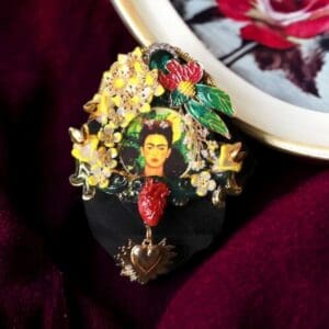 A close up of a necklace with flowers and a picture