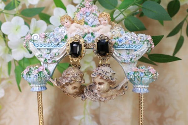 A pair of earrings with faces on them