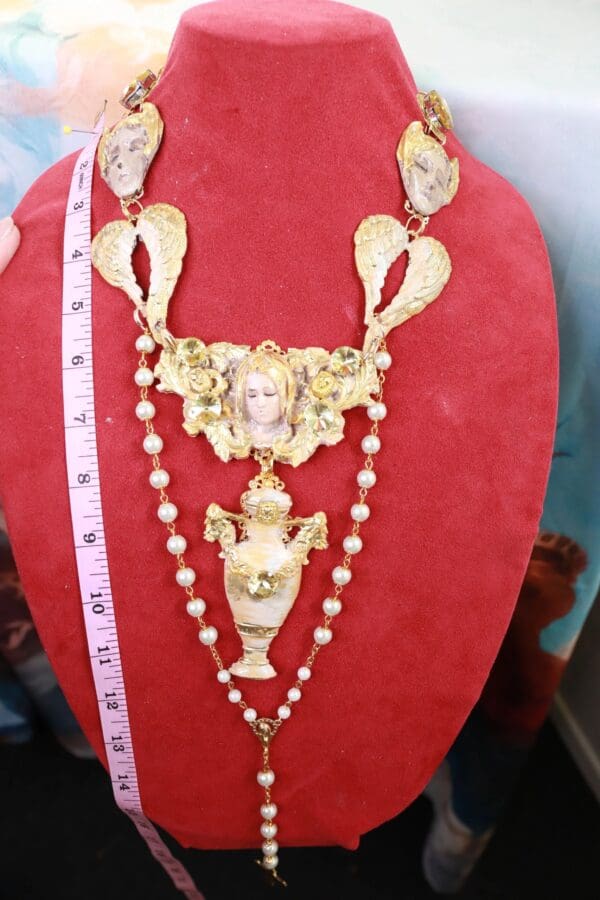 A red display case with a necklace and measuring tape.
