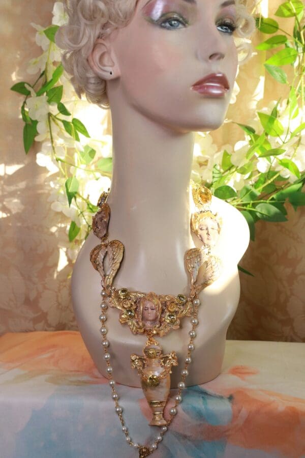 A mannequin wearing a necklace and earrings.