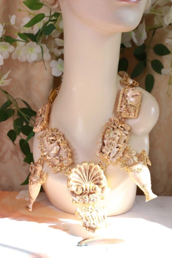 A white vase with gold accents on top of the table.
