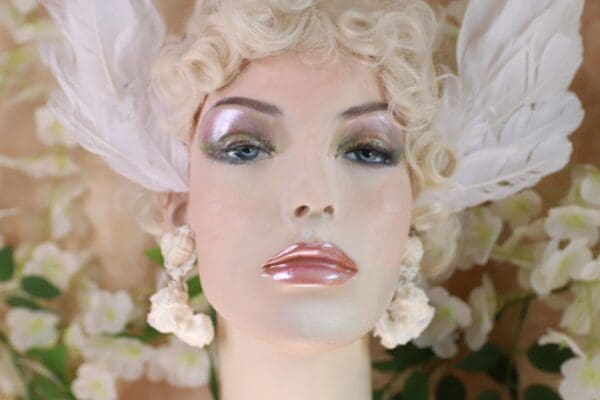A mannequin with white feathers on her head.
