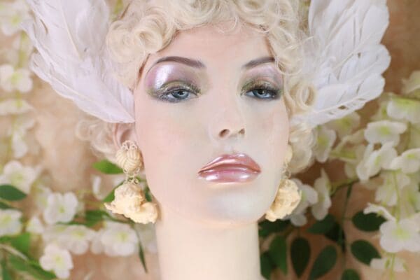 A mannequin with white feathers on her head.