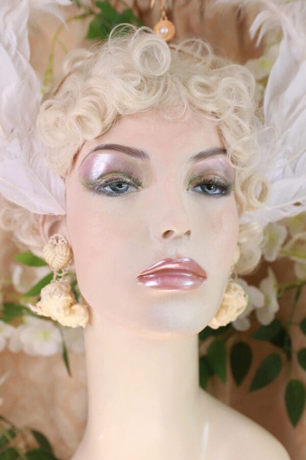 A mannequin with white feathers on her head.