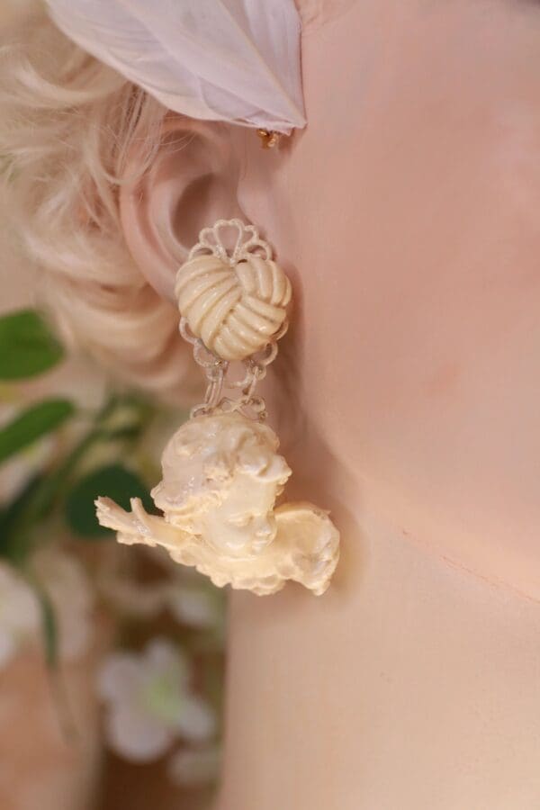 A woman with blonde hair wearing earrings.