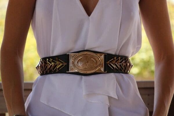 A woman wearing a white dress and belt