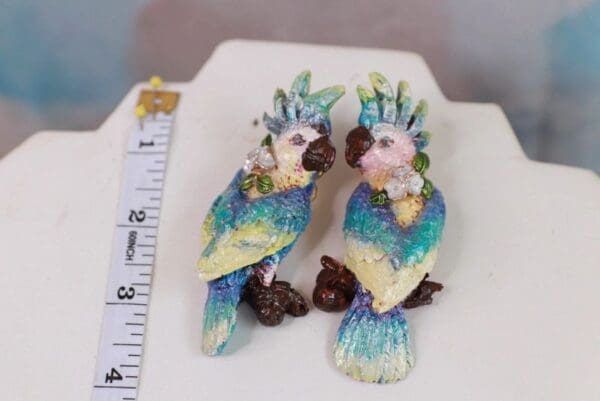 A pair of colorful birds sitting on top of a table.